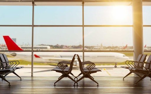 Airport seating area with a plane on the tarmac at Sabiha Gokcen Airport, Istanbul.