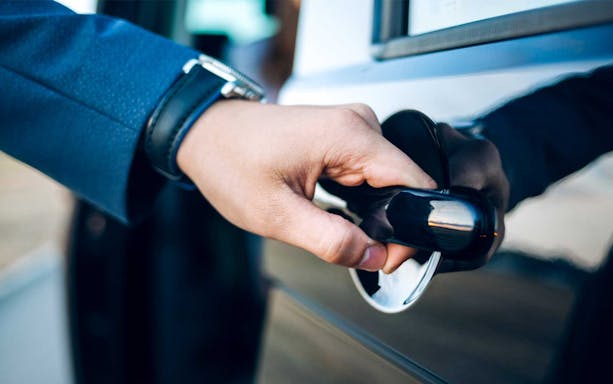 Hand opening car door for Sabiha Gokcen Airport shared transfer in Istanbul.