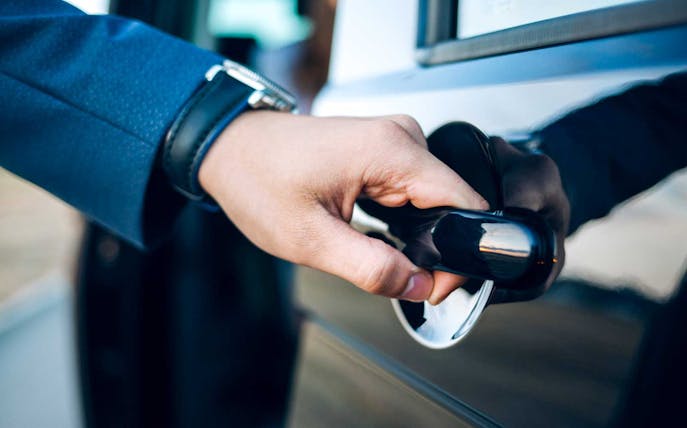 Hand opening car door for Sabiha Gokcen Airport shared transfer in Istanbul.