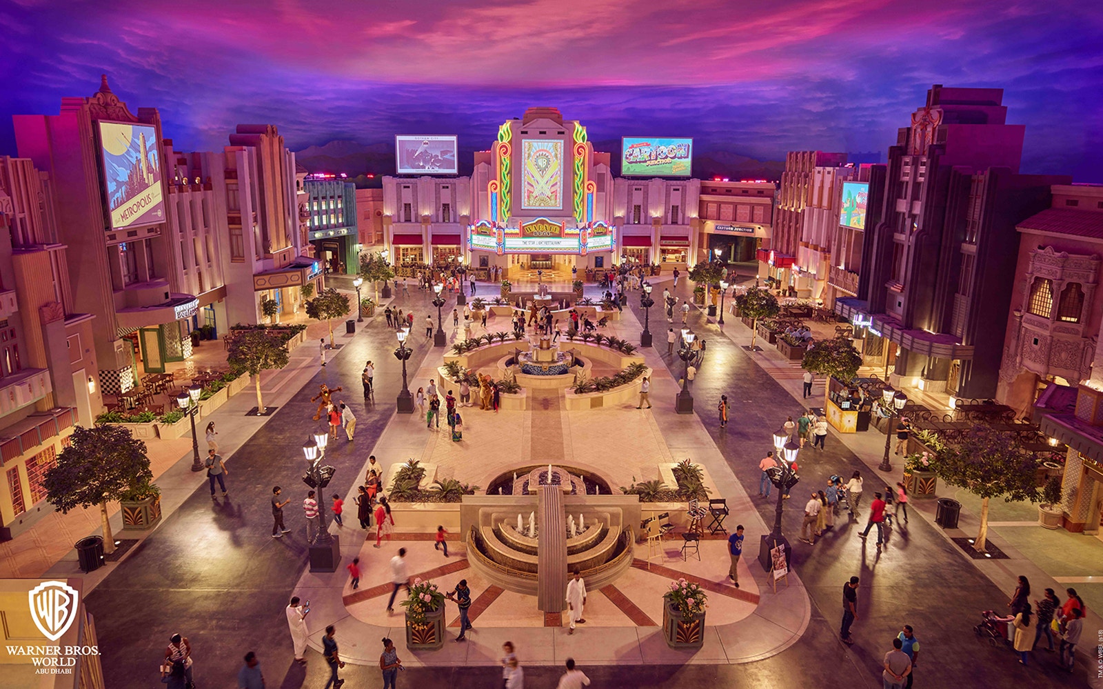 Warner Bros. World entrance with iconic characters, Abu Dhabi, and Ferrari World roller coaster in the background.