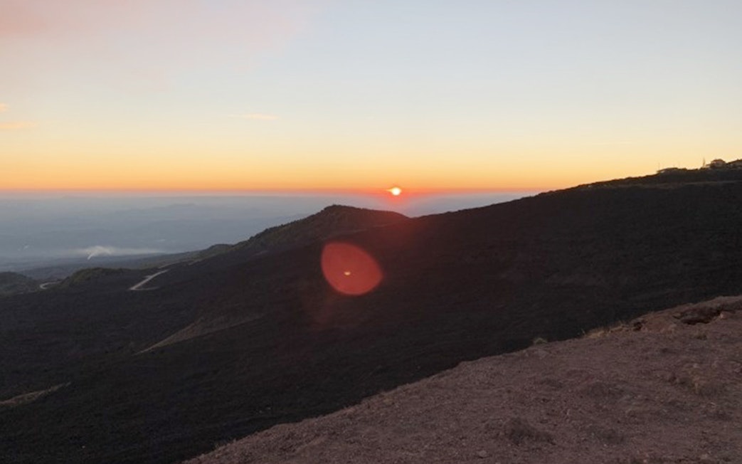 Sunset view over Mount Etna's rugged landscape during a Jeep tour.