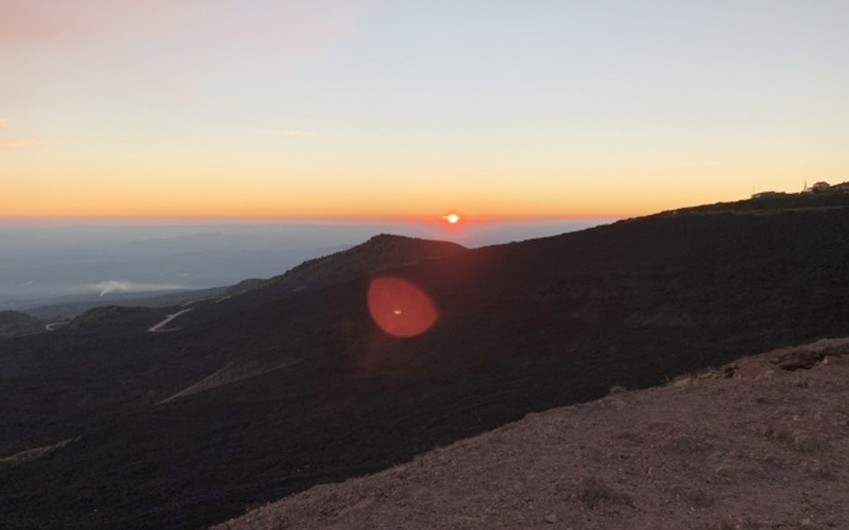 Sunset view over Mount Etna's rugged landscape during a Jeep tour.