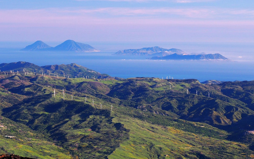 Mount Etna landscape with wind turbines and distant islands, Sicily Jeep tour.