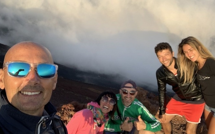 Group enjoying Mount Etna Jeep tour with wine tasting, Sicily.