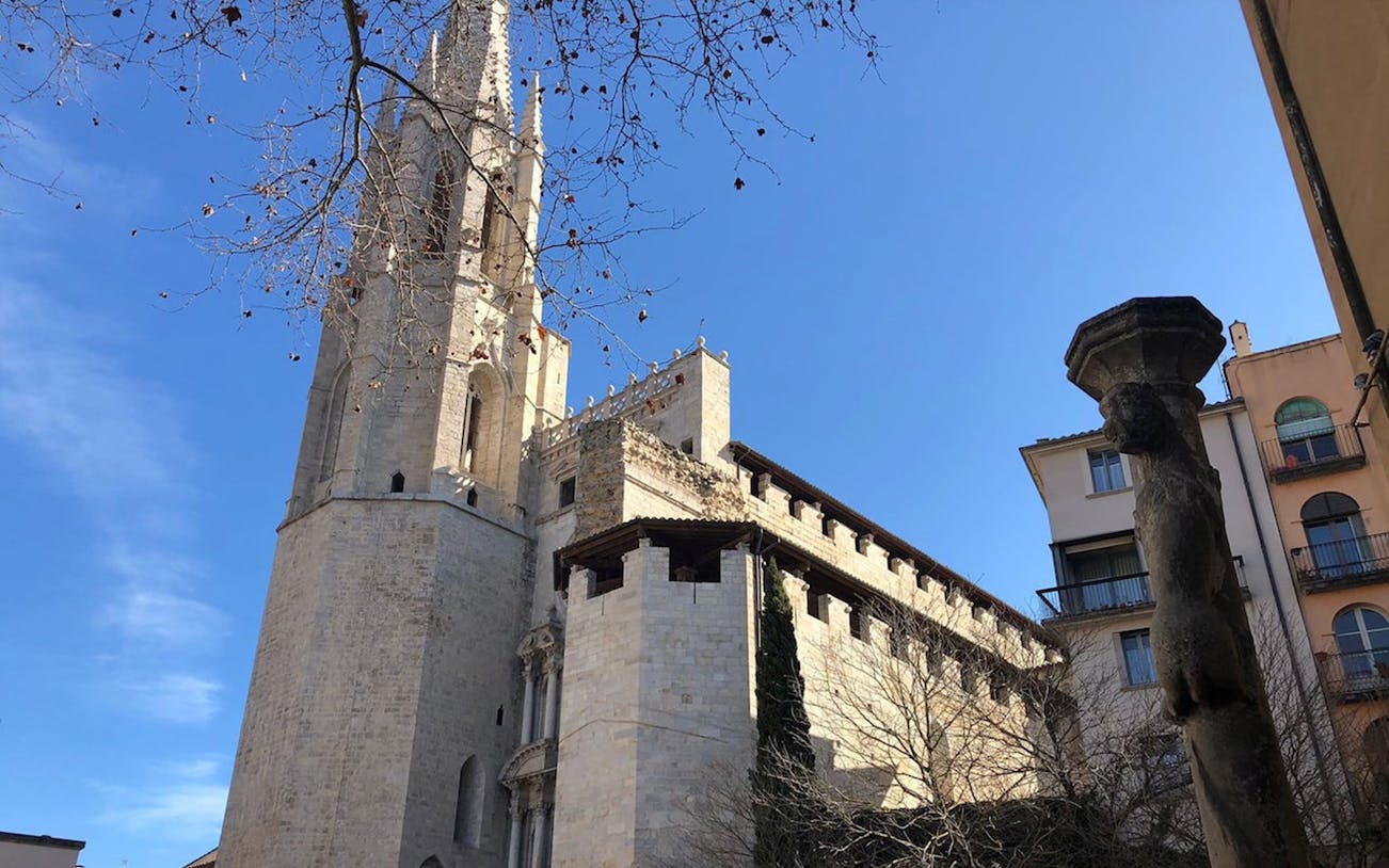 Gothic cathedral tower in Girona, Spain, viewed from a courtyard on the Monumental Girona Tour.