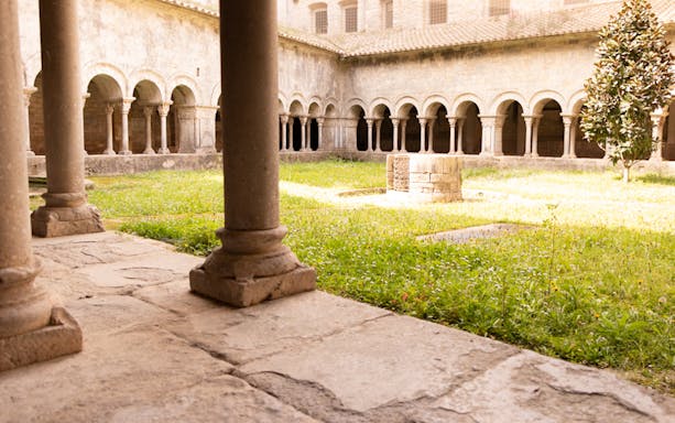 Cloister courtyard with stone columns in Girona, Spain.