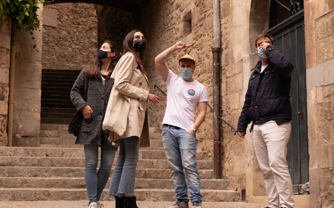 Group exploring medieval stone streets in Girona tour.