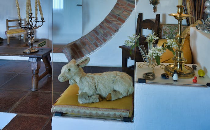 Stuffed rabbit on a cushion with decorative items in Dalí's house, Portlligat.