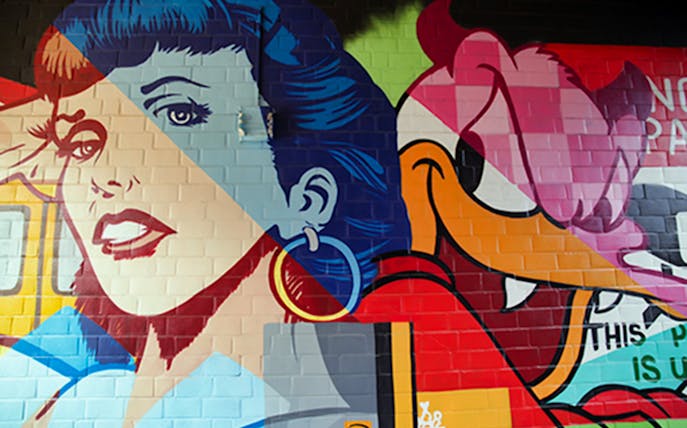 Berlin street art mural featuring colorful pop art characters.
