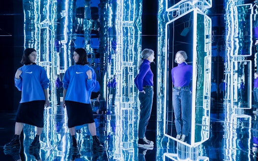 Visitors exploring mirrored art installation at Youseum.