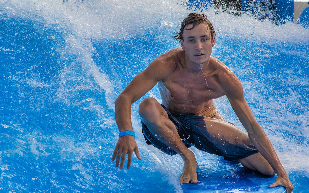 Surfer riding FlowRider wave in Cancun.