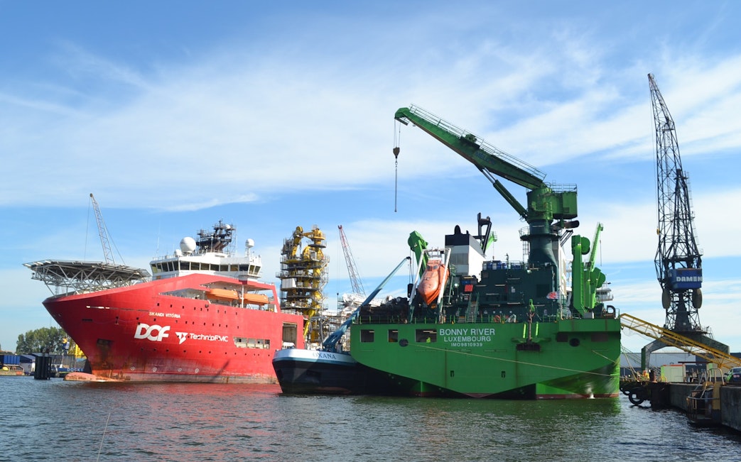 Docked ships and cranes at Port of Amsterdam during harbor tour.