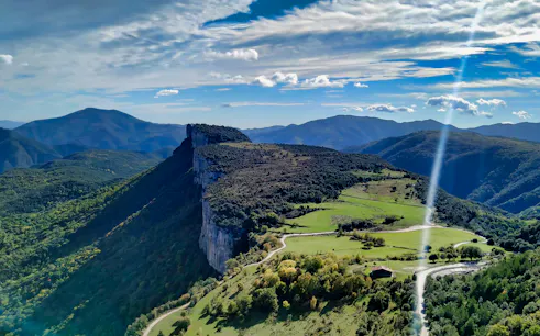 Rugged cliffs and green valleys in rural Catalonia near Rupit, ideal for hiking adventures.