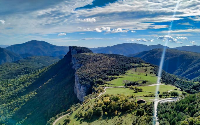 Rugged cliffs and green valleys in rural Catalonia near Rupit, ideal for hiking adventures.