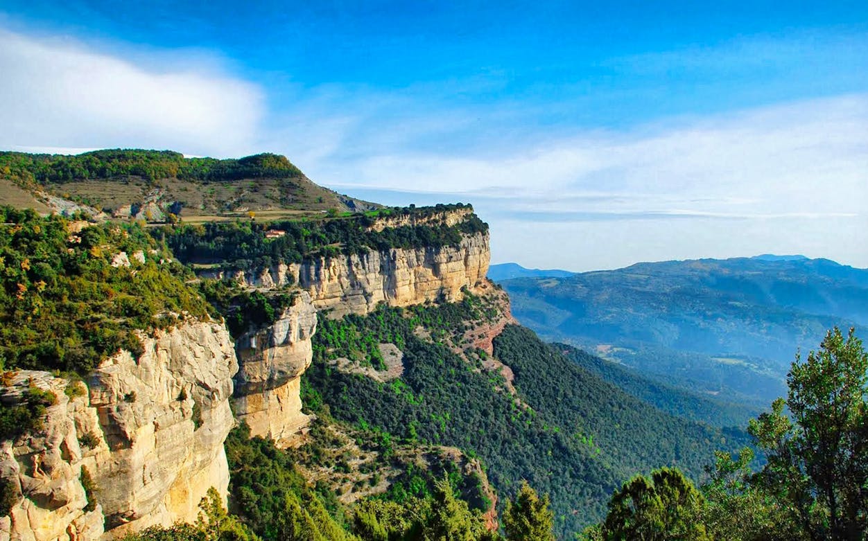 Cliffs and lush landscape in rural Catalonia near Rupit, ideal for hiking experiences.