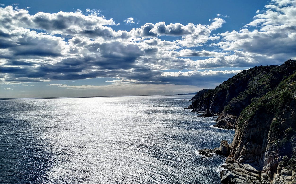 Coastal cliffs and ocean view on the Tossa de Mar hiking trail, Costa Brava.