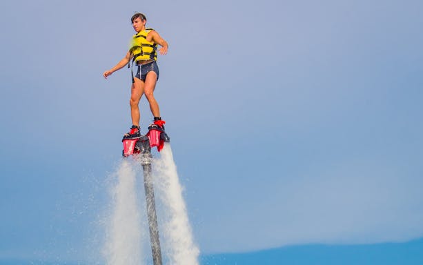 Person flyboarding over water in Barcelona.