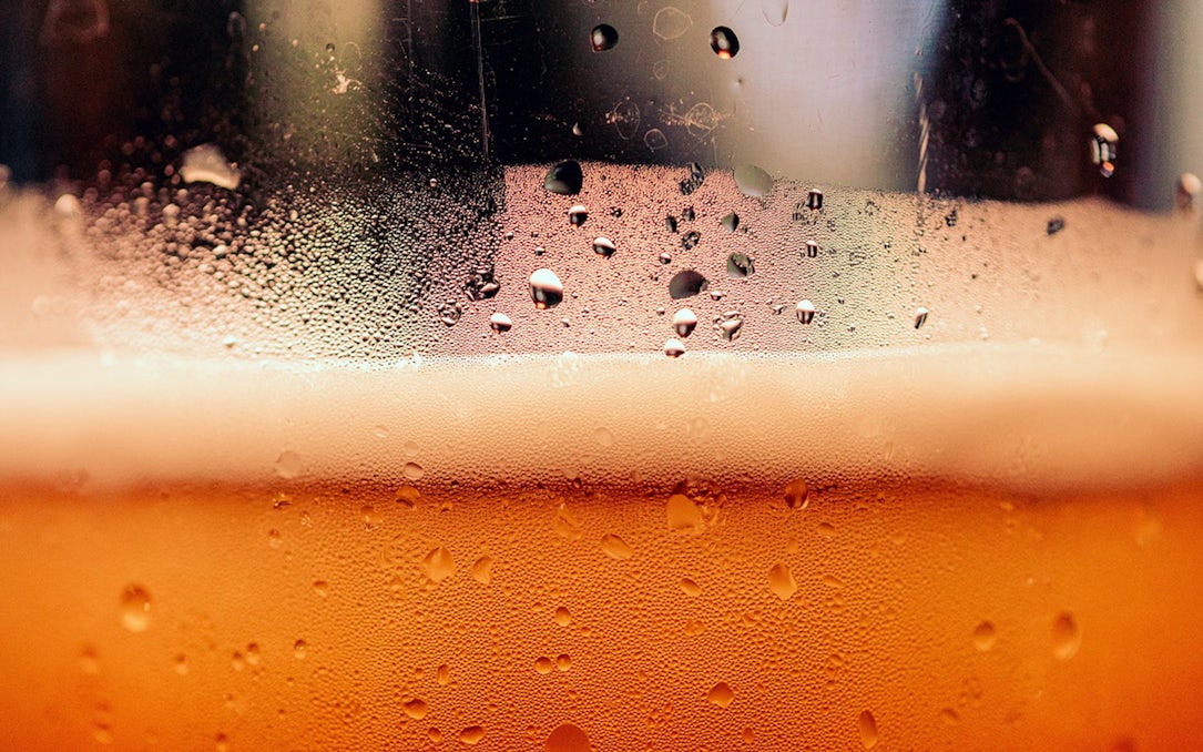 Close-up of beer with foam and condensation, part of a Prague beer tasting tour.