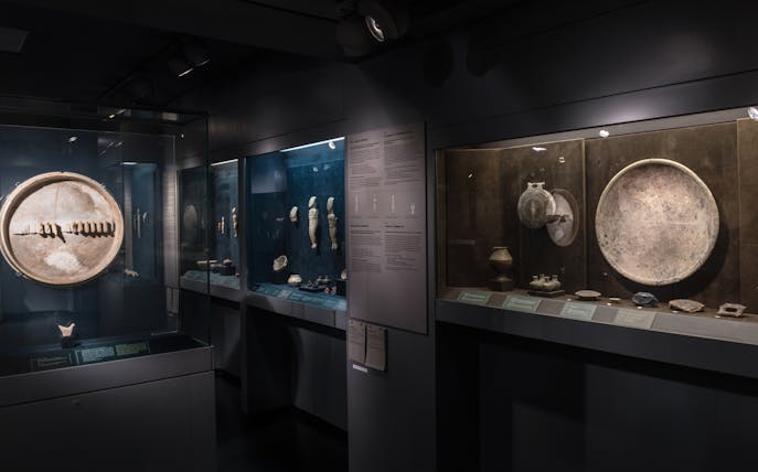 Cycladic artifacts displayed in Athens Museum of Cycladic Art exhibit.