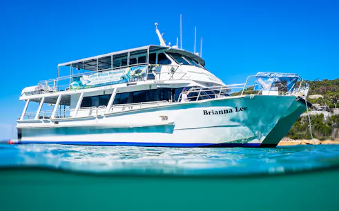 Cruise boat "Brianna Lee" on Wilsons Promontory waters, Australia, under clear blue sky.