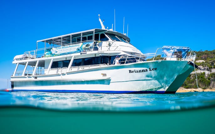 Cruise boat "Brianna Lee" on Wilsons Promontory waters, Australia, under clear blue sky.