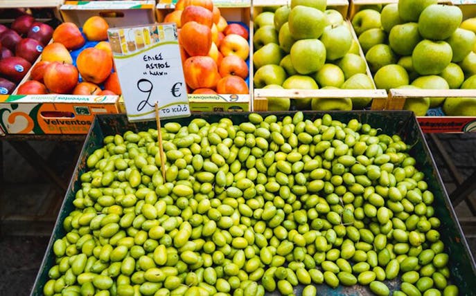 Green olives and fresh fruit at Athens food market.