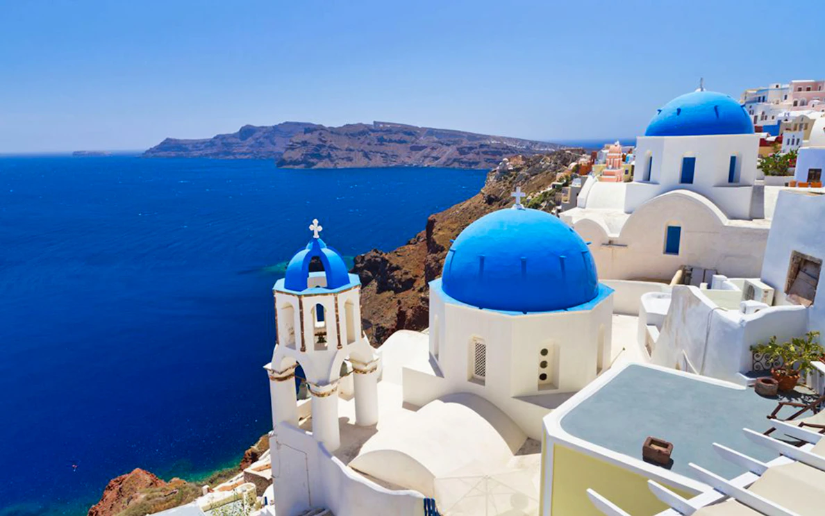 Santorini blue domes overlooking the Aegean Sea on a bus tour.
