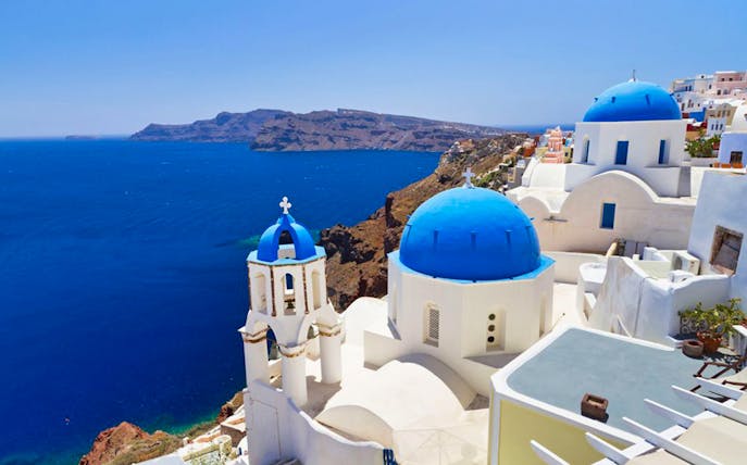 Santorini blue domes overlooking the Aegean Sea on a bus tour.