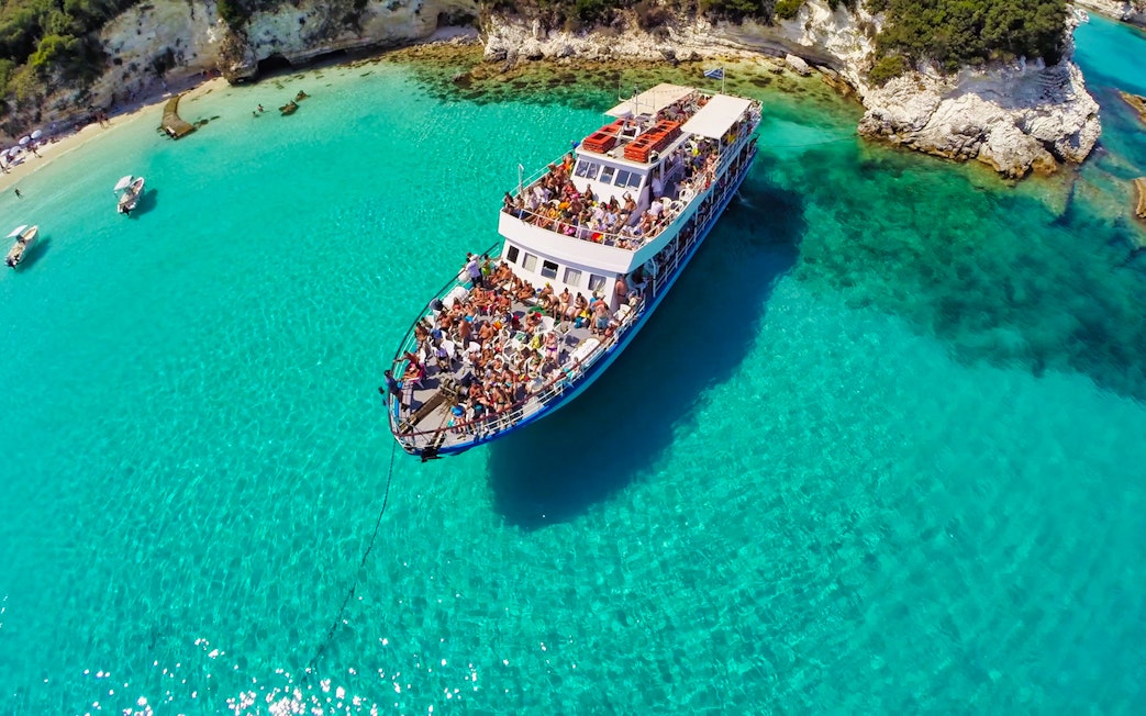Cruise ship on clear blue waters near Paxos and Antipaxos islands.