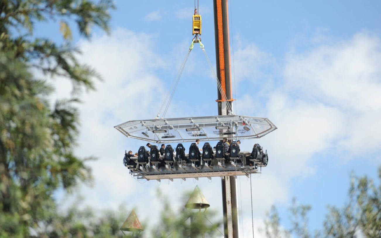 Guests dining on a suspended platform during Dinner in the Sky Athens experience.