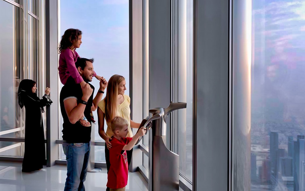 Visitors enjoying the view from Burj Khalifa observation deck in Dubai.