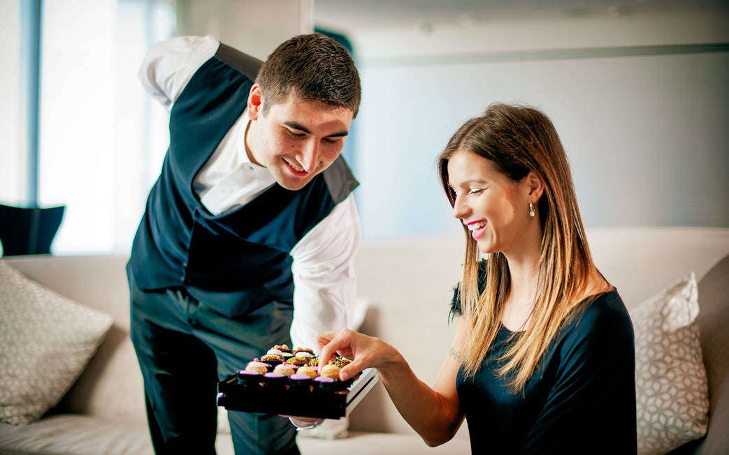 Server offering pastries to a woman at The Café, Burj Khalifa.