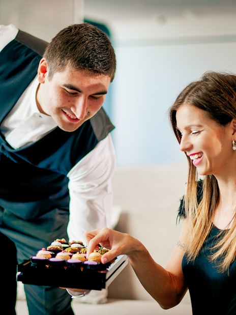 Server offering pastries to a woman at The Café, Burj Khalifa.