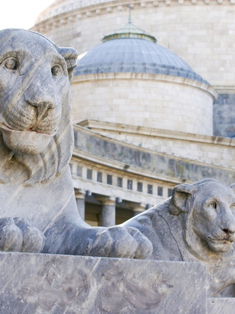 Stone lion statues at Piazza del Plebiscito, Naples, Italy.