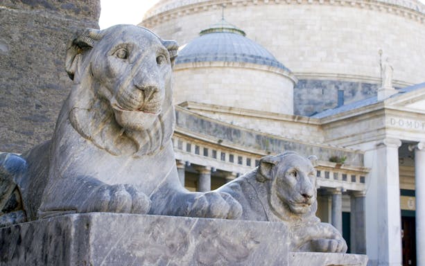 Stone lion statues at Piazza del Plebiscito, Naples, Italy.