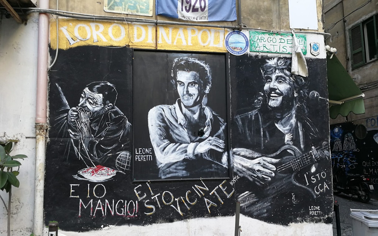 Street mural in Naples featuring Diego Maradona and local cultural icons.
