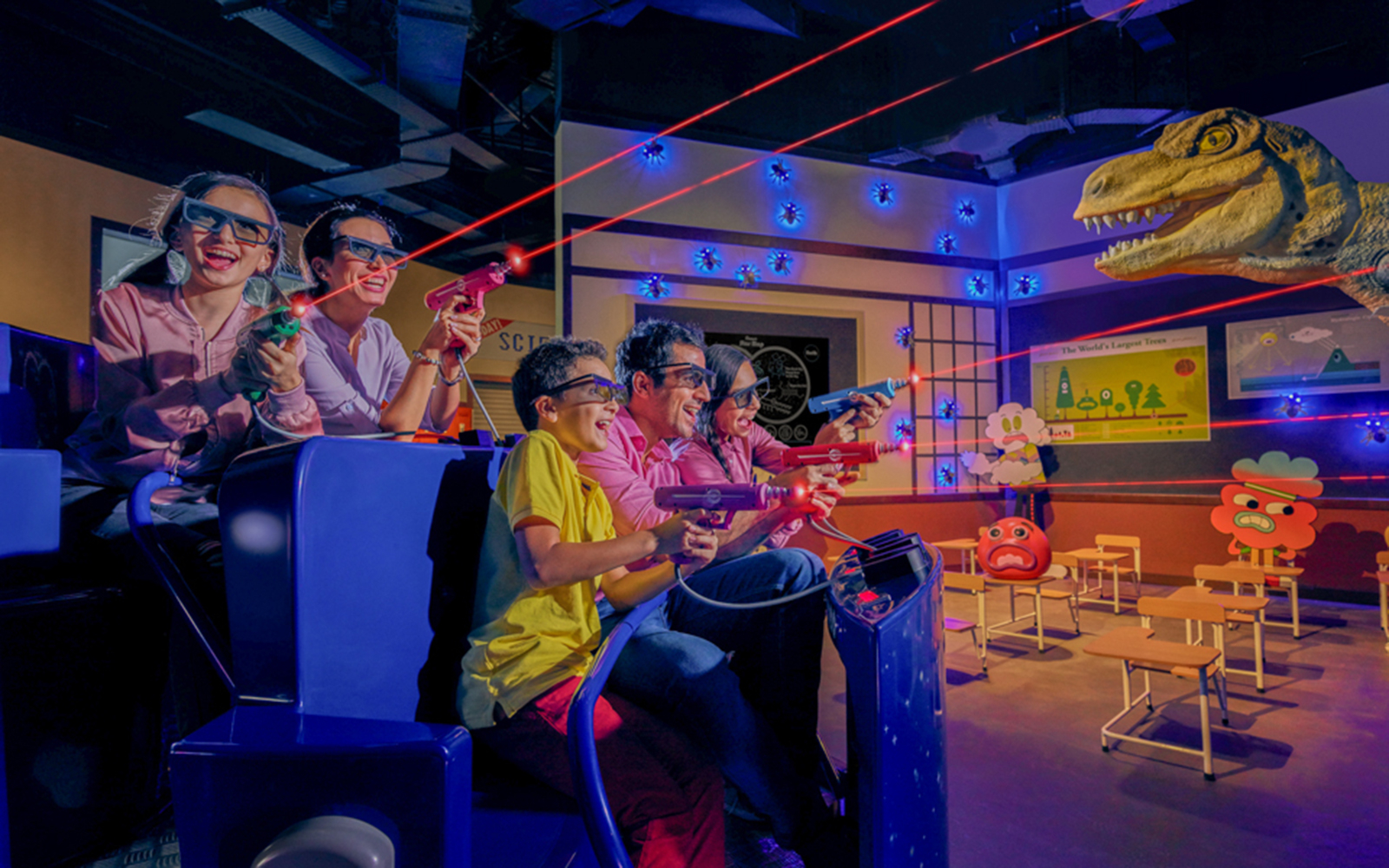 Family enjoying a laser shooting ride at IMG Worlds of Adventure, Dubai.