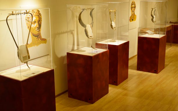 Ancient Greek lyres displayed in a museum exhibit on technological advancements.