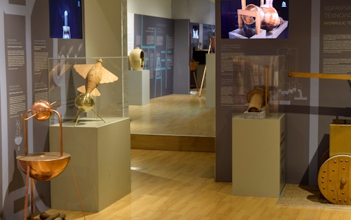 Ancient Greek technology exhibit with hydraulic devices and inventions on display.