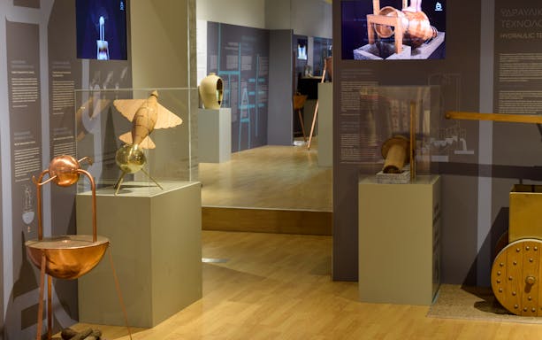 Ancient Greek technology exhibit with hydraulic devices and inventions on display.
