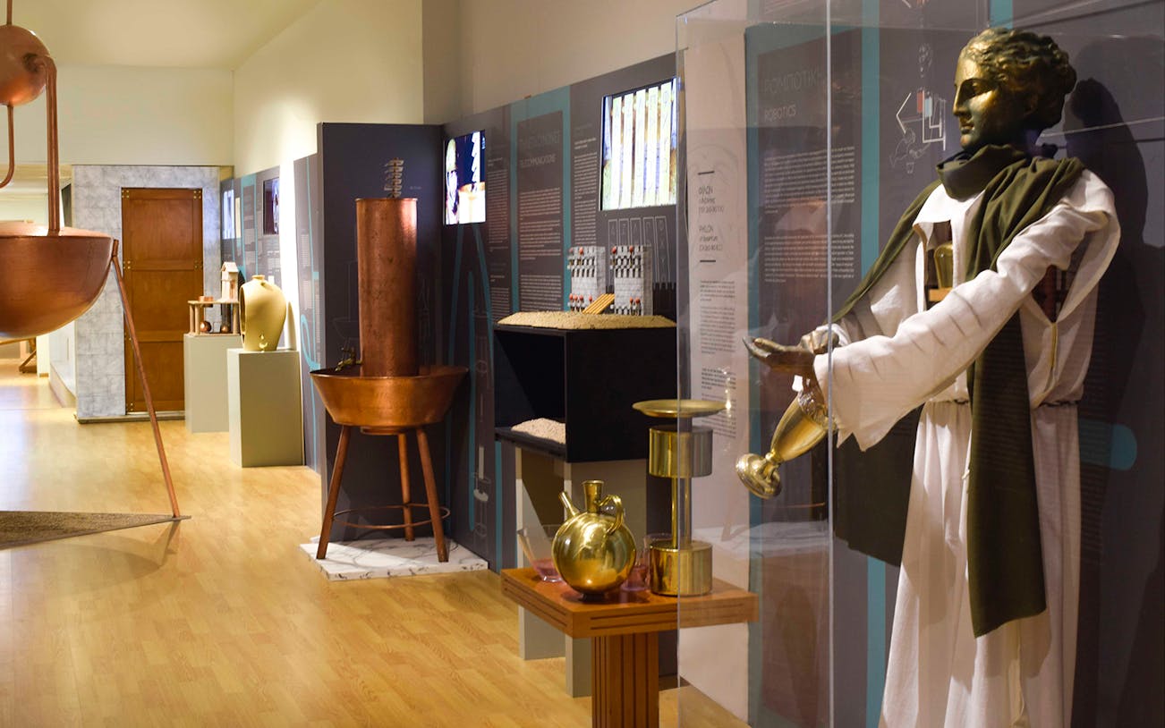 Ancient Greek technology exhibit with automaton and hydraulic devices.