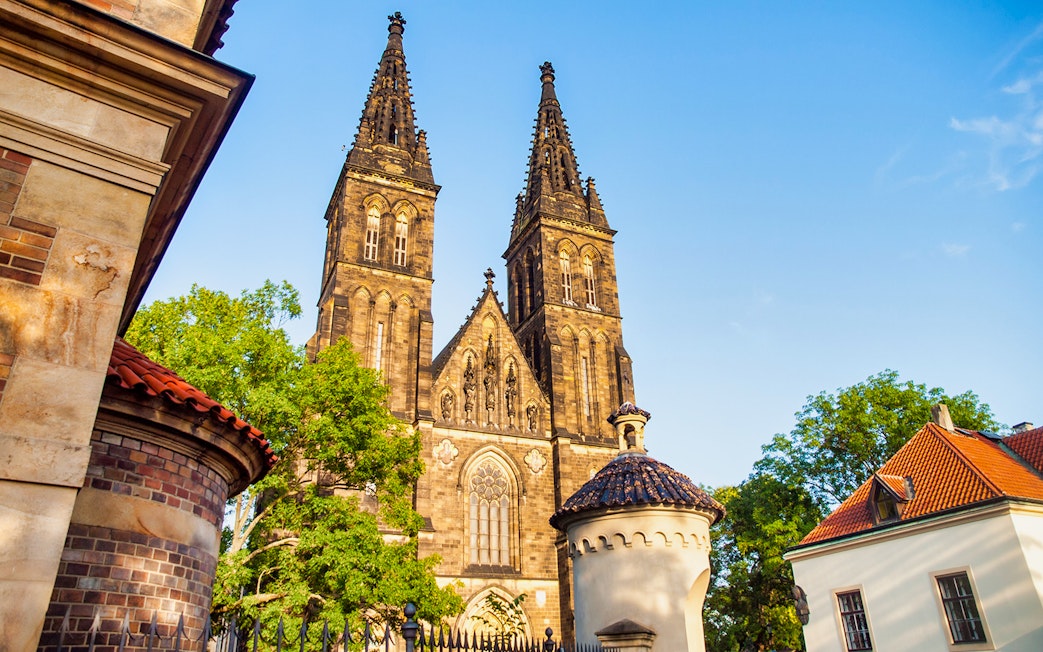 Vyšehrad Castle's twin spires and surrounding architecture in Prague.