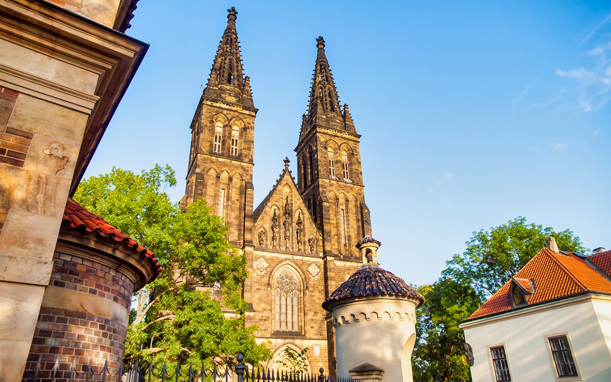Vyšehrad Castle's twin spires and surrounding architecture in Prague.