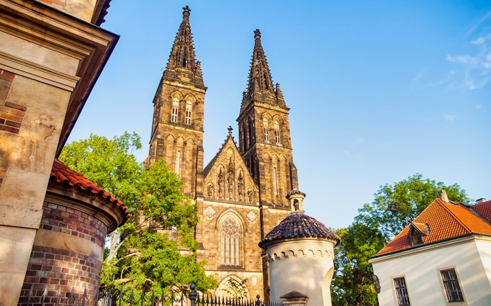 Vyšehrad Castle's twin spires and surrounding architecture in Prague.