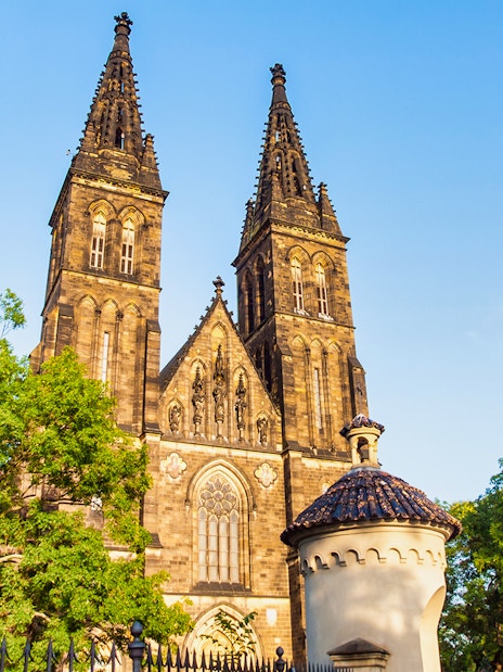 Vyšehrad Castle's twin spires and surrounding architecture in Prague.