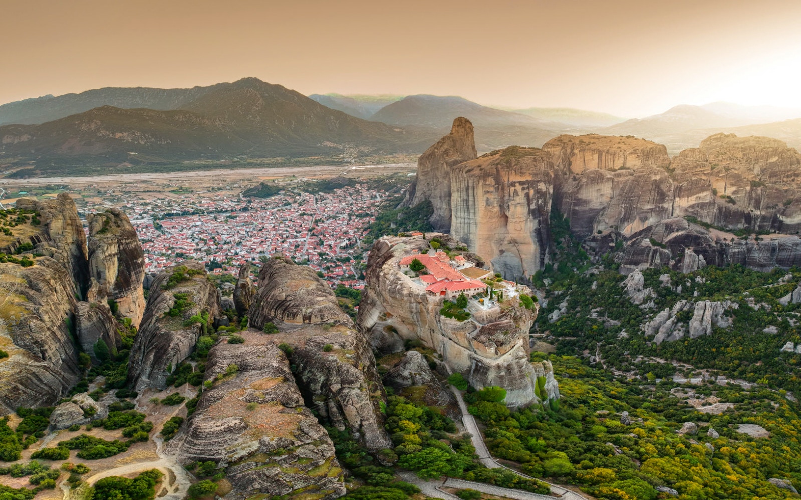 Meteora rock formations with monastery near Kalabaka, Greece, viewed from above.