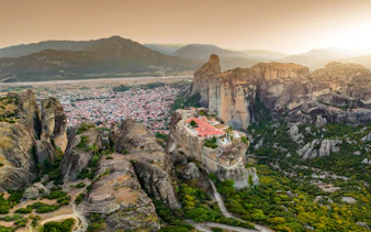 Meteora rock formations with monastery near Kalabaka, Greece, viewed from above.
