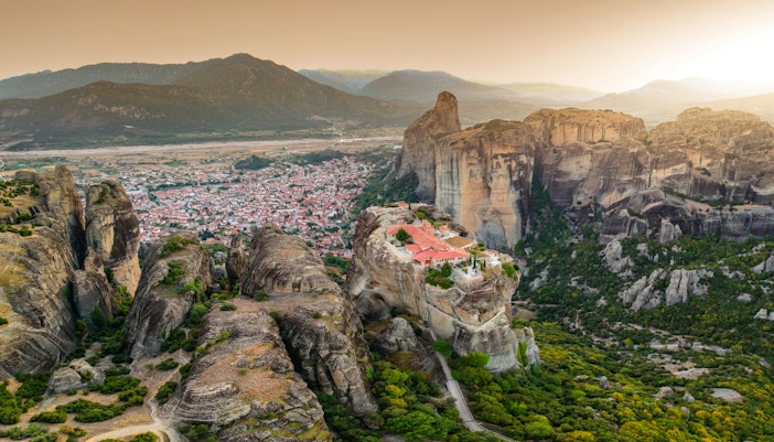 Meteora rock formations with monastery near Kalabaka, Greece, viewed from above.
