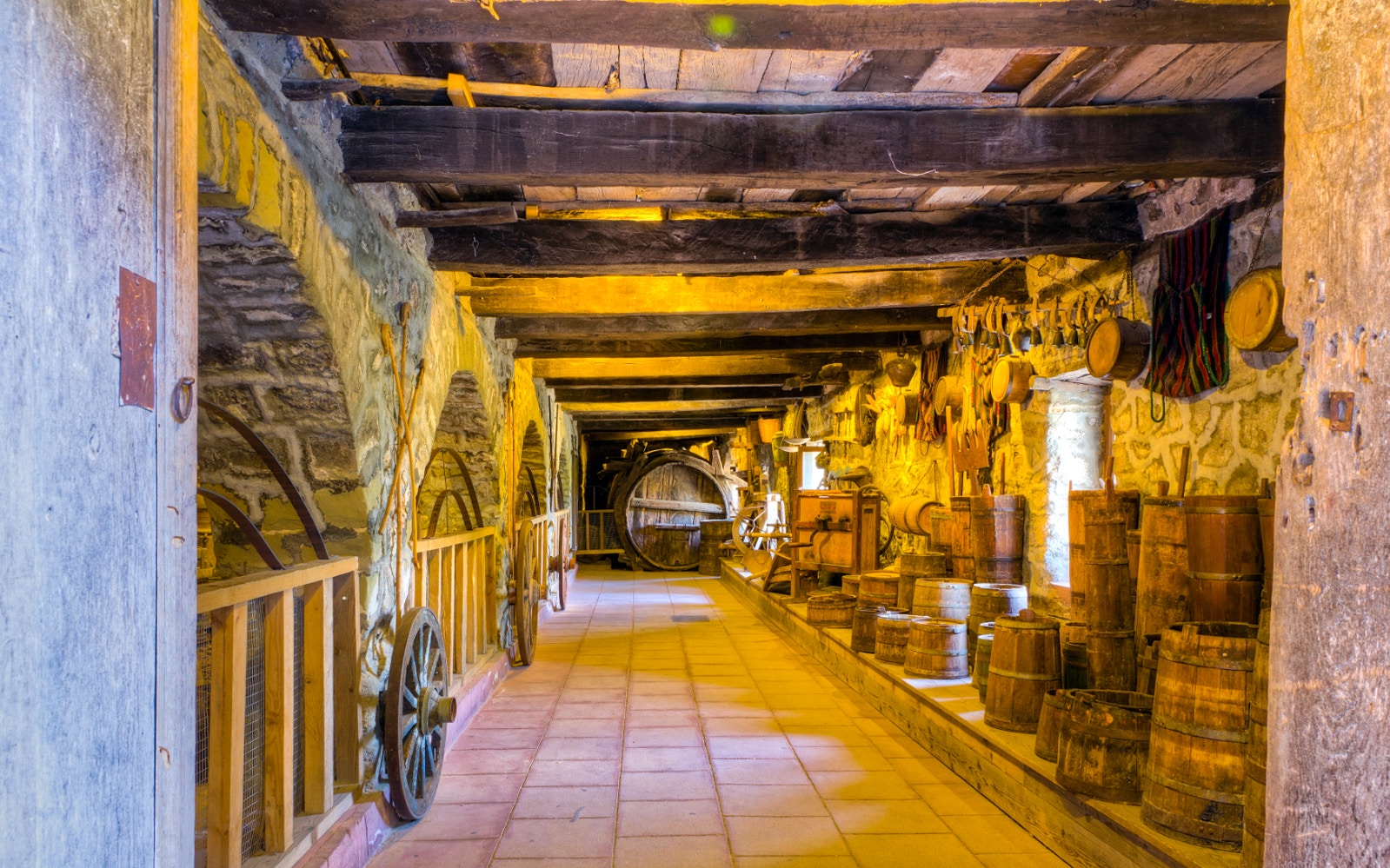 Traditional Greek cellar with wooden barrels and tools, part of Meteora tour from Kalabaka.