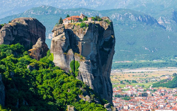 Monastery atop rock formation in Meteora, Greece, with Kalabaka town below.